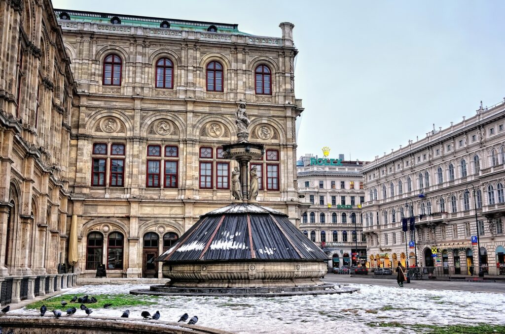 Picturesque Vienna Wallpaper: Historic Architecture & Snowy Fountain