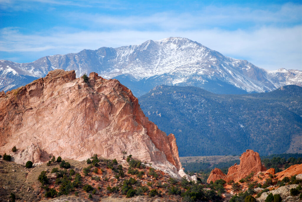 Pikes Peak Colorado with rugged red rocks and snow-capped mountains under clear blue sky wallpaper