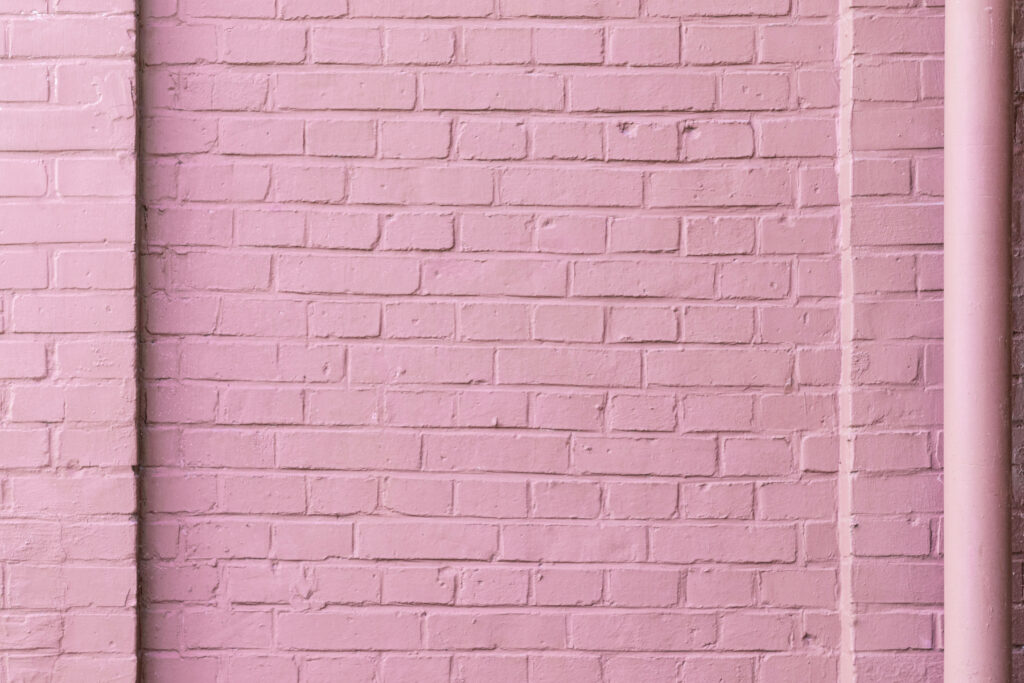 Pretty in Pink: A Captivating 4k Desktop Wallpaper of a Textured Bricked Wall