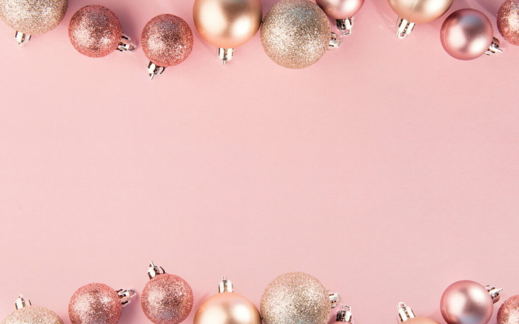 Elegant pink Christmas wallpaper with glitter frame and metallic baubles on soft background