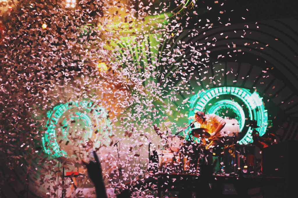 Mesmerizing Stage with Pink Confetti Showers: HD Wallpaper Background Exuding Energetic Vibes