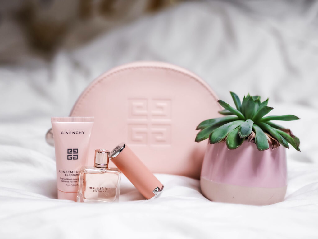 Pink Elegance: Enchanting Givenchy Makeup and Posh Pouch with Vibrant Pink Succulent Set Against a White Background Wallpaper