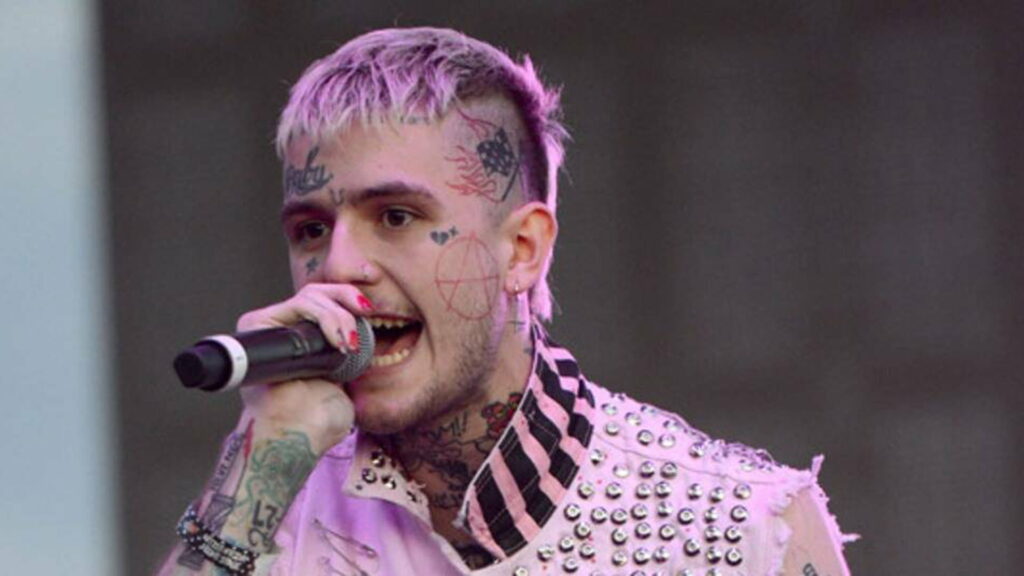 Lil Peep live concert wallpaper with pink hair face tattoos and pink studded vest emo rap style