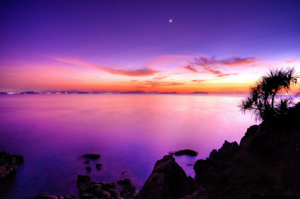 Majestic Pink Sunset Reflection on Water with Silhouette of Rocky Cliffs- Desktop Background Wallpaper