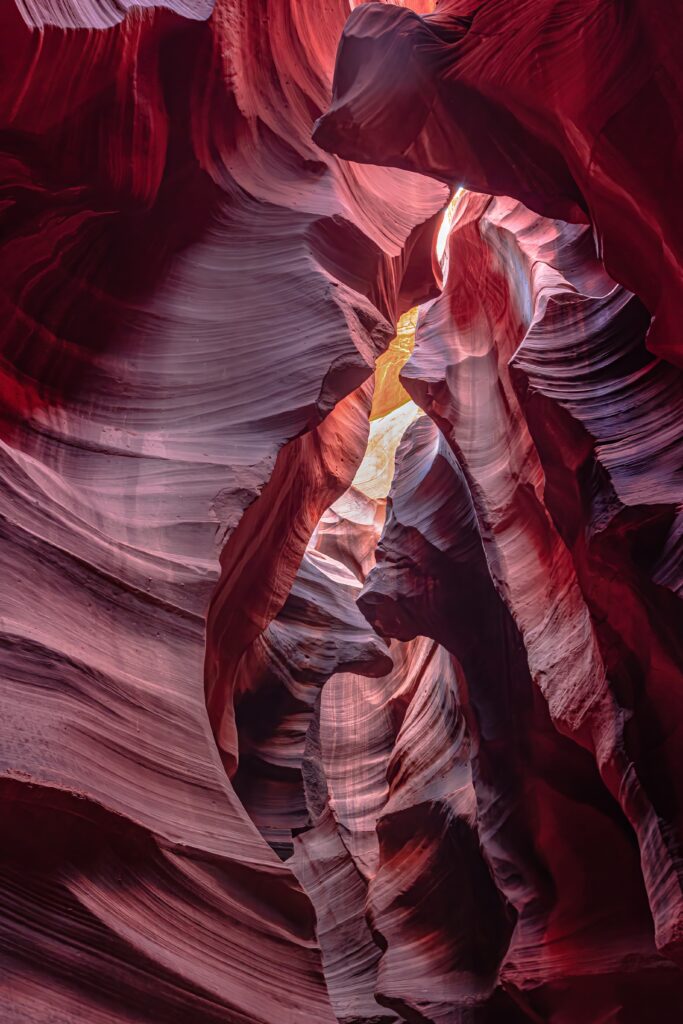 Stone gorge wallpaper with pink light rays intricate textures and dramatic shadows natural landscape