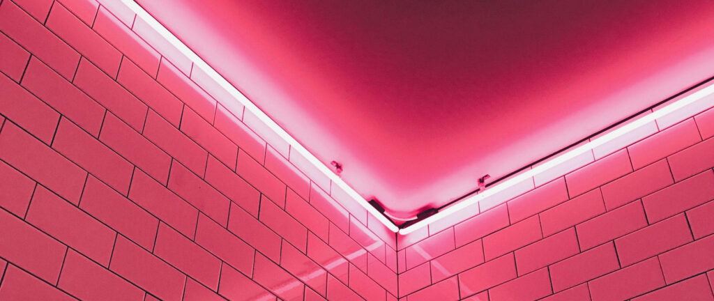 Vibrant Low-angle Shot: Mesmerizing Pink Tile Glow with Neon LED Lighting Wallpaper