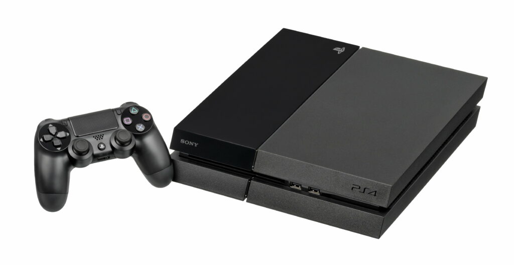 Black Sony PlayStation 4 console with DualShock 4 controller studio-lit wallpaper background