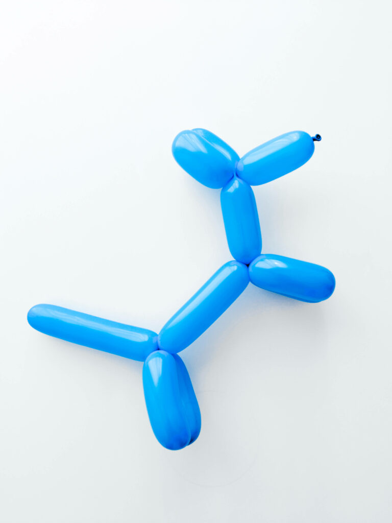 Playful blue dog toy balloon on clean white background whimsical fun wallpaper design