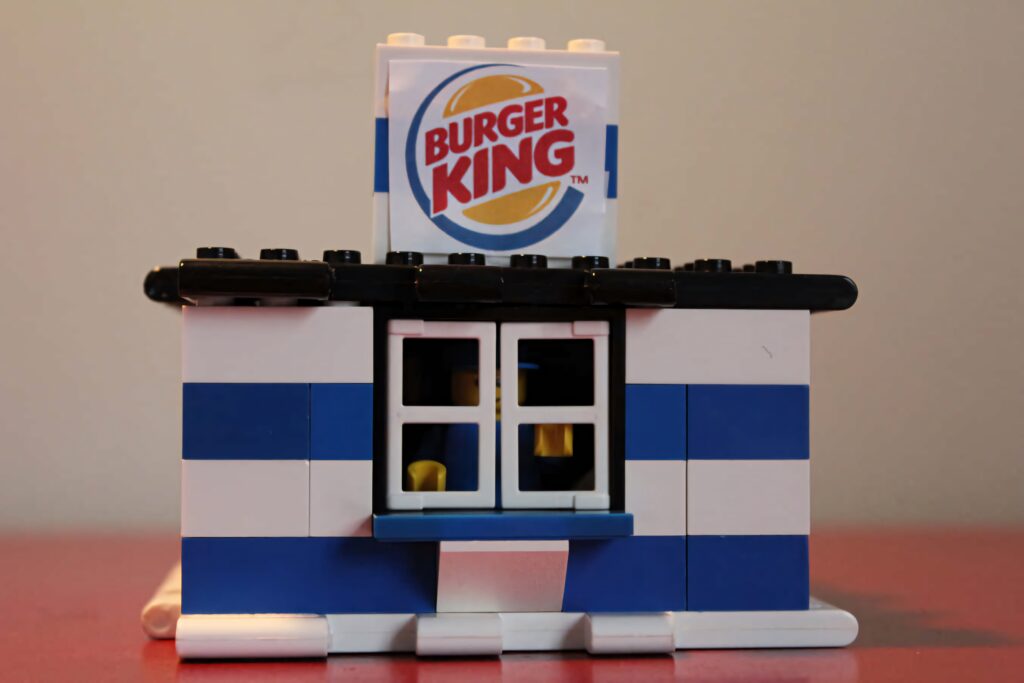 Playful Burger King LEGO restaurant wallpaper with blue white bricks and iconic logo background