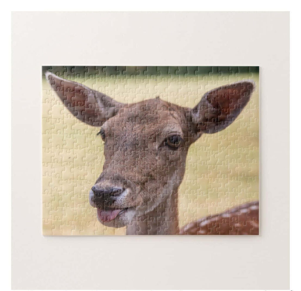 Playful Deer Wallpaper: Humorous Tongue-Out Puzzle Design