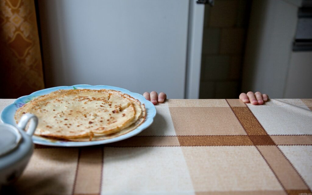 Playful Pancakes on a Checkered Tablecloth - Wallpaper Background