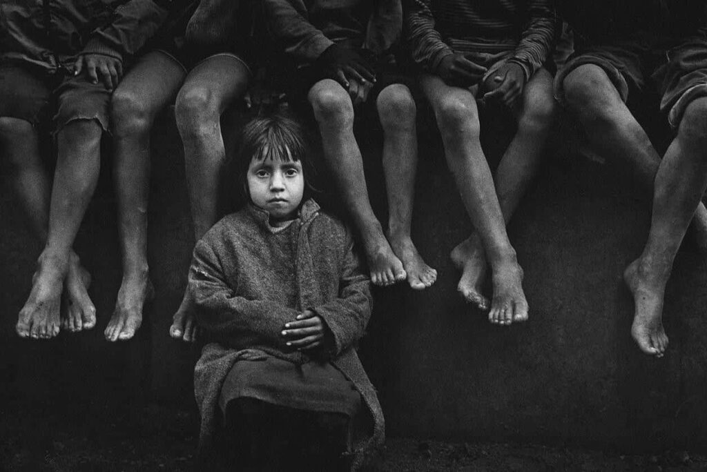 Poignant Black and White Wallpaper of a Girl in a Poverty Scene