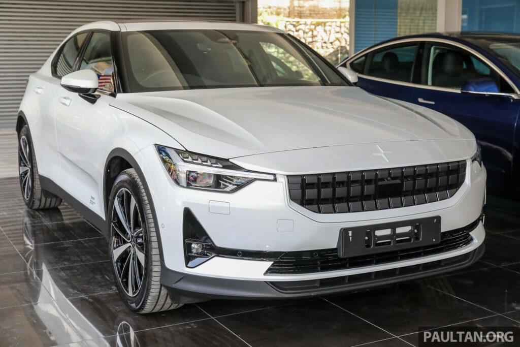 Polestar 2 electric car in modern showroom with sleek white finish highlighting design features Wallpaper