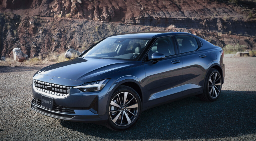 Polestar 2 parked in rugged desert with rocky terrain and clear open sky background wallpaper
