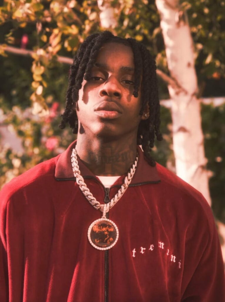 HD Phone Wallpaper: Enigmatic Polo G, a Trailblazing Rapper in a Captivating Blurred Background