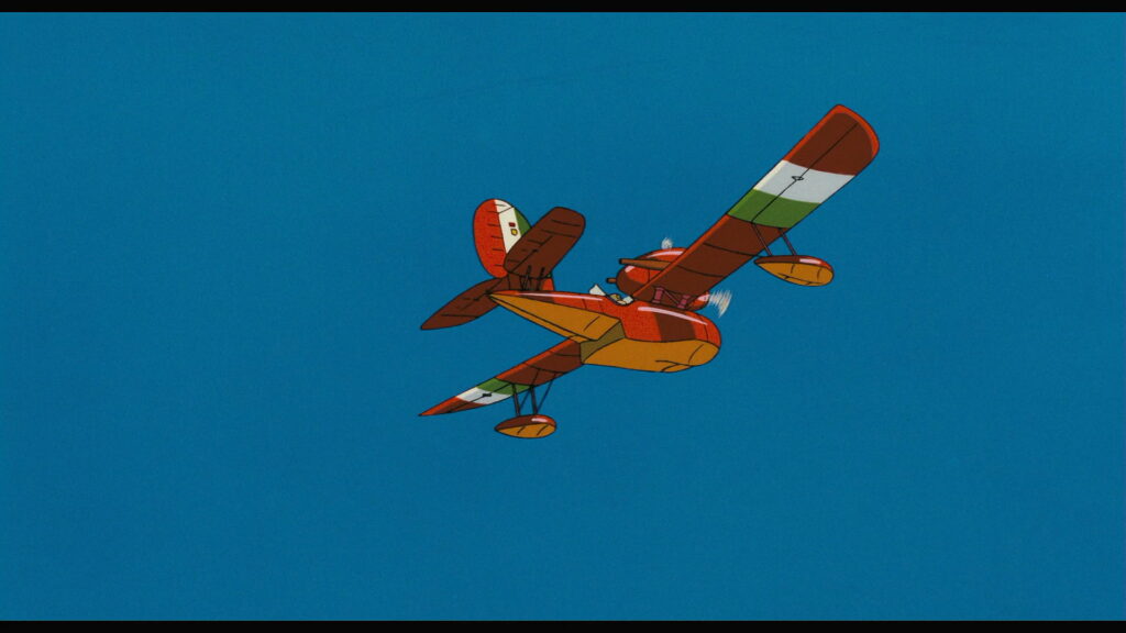 Porco Rosso HD wallpaper: Crimson plane soars through azure sky, embodying freedom and adventure in Studio Ghibli classic