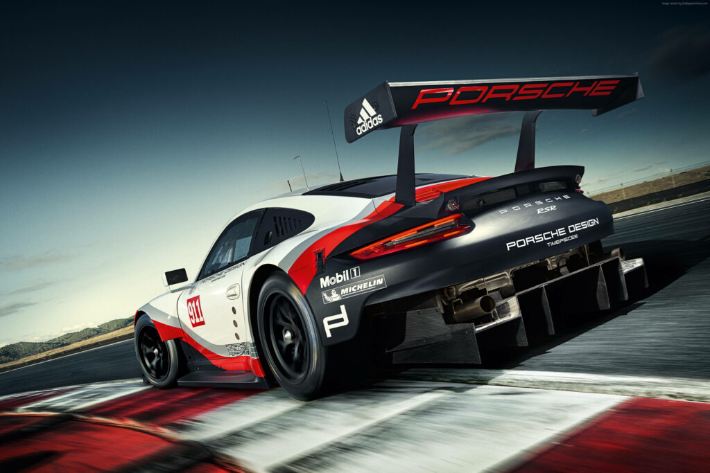 Porsche 911 racing car speeding on track dynamic wallpaper showcasing sporty aerodynamic design