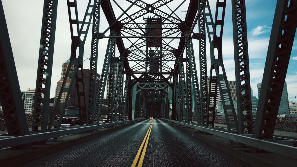 Portland Steel Bridge steel truss with city skyline and bright yellow road line wallpaper background