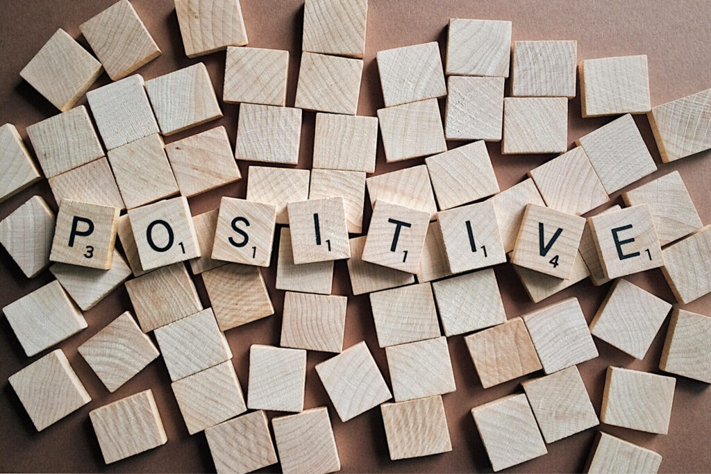 Positivity in Scrabble: Motivational Laptop Wallpaper featuring Wooden Tiles