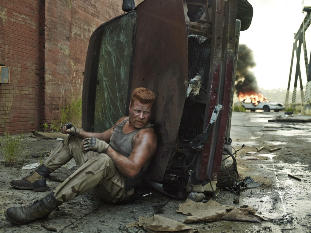 Post-Apocalyptic Wallpaper: Abraham Hiding by Overturned Vehicle