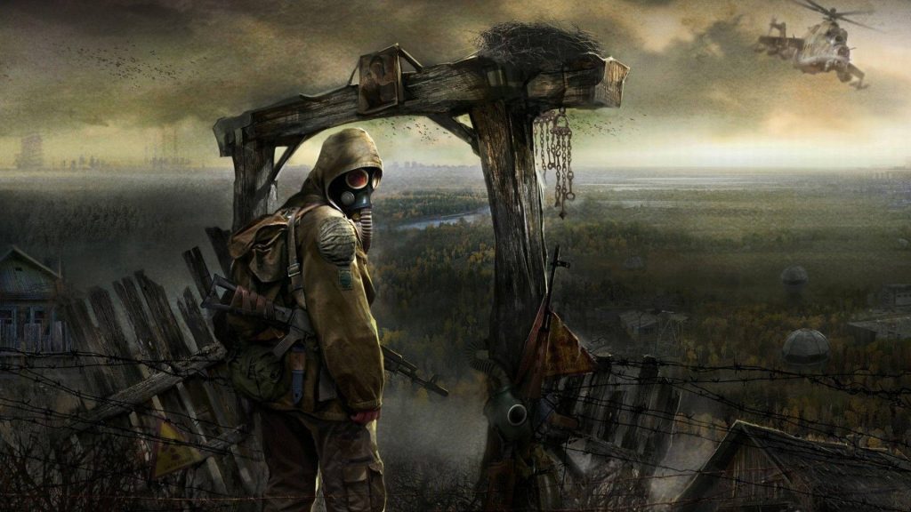 Lone gas mask survivor by barbed wire in post-apocalyptic radioactive wasteland wallpaper