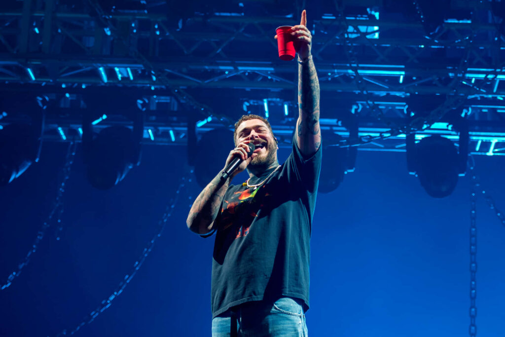 Vibrant Post Malone Performance at Ryman Auditorium - Energetic Wallpaper