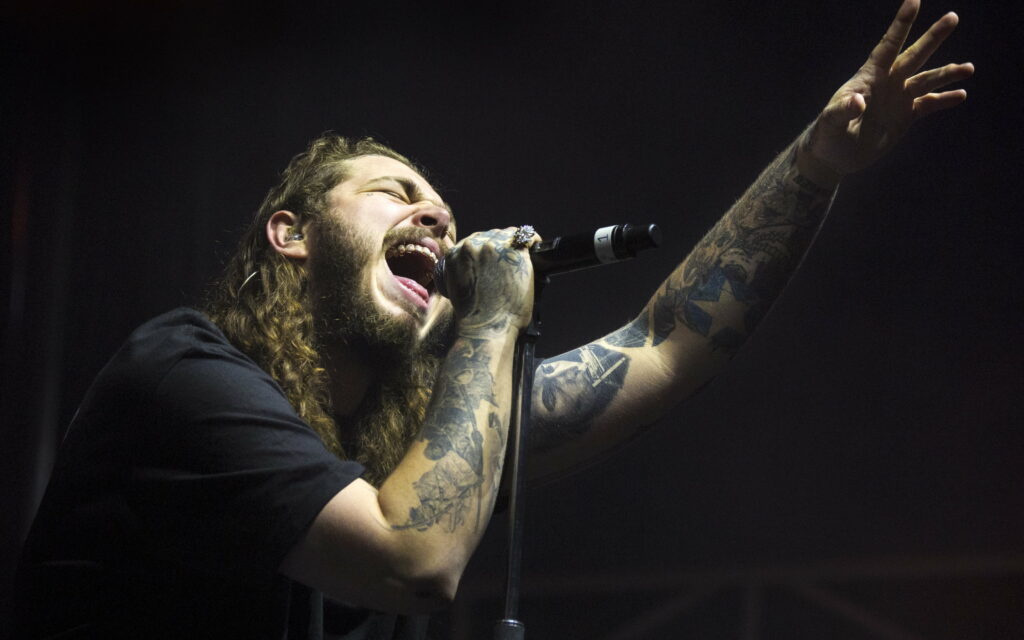 Post Malone: Rocking the Stage with Superstar Status at Concert Wallpaper