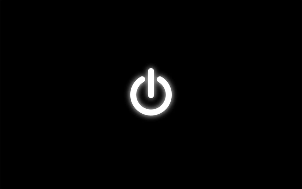 Glowing Power Button on a Black Background Wallpaper