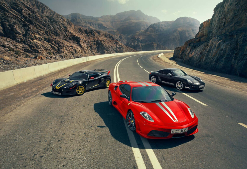 Capturing the Thrilling Essence of the Red Ferrari F430 Racing against Nature's Beauty Wallpaper