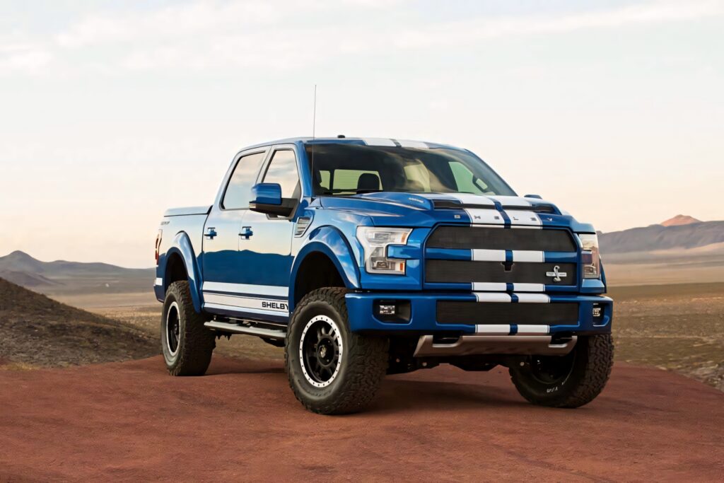 Bold blue Ford truck parked in rugged desert landscape high performance wallpaper background