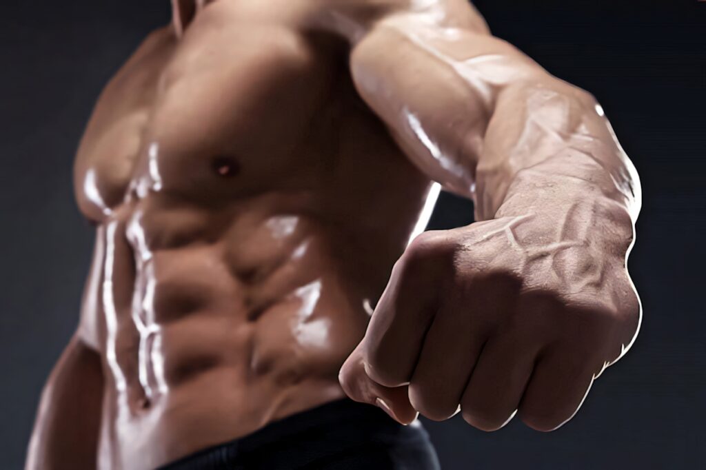 Bodybuilder showing muscular physique with defined abs and clenched fist in high definition pose Wallpaper