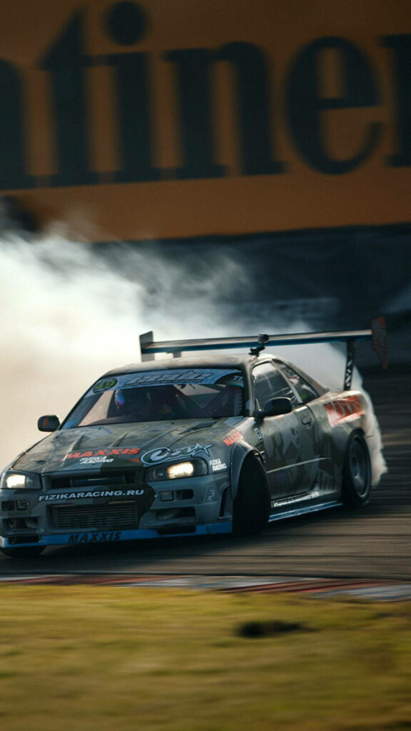 JDM car drifting on race track with aggressive body kit and smoke clouds dynamic wallpaper background