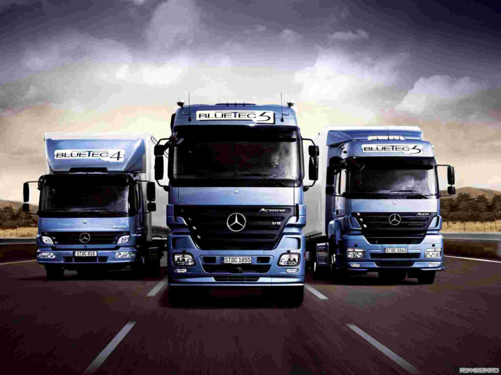 Powerful Mercedes-Benz Trucks Wallpaper Against Dramatic Sky