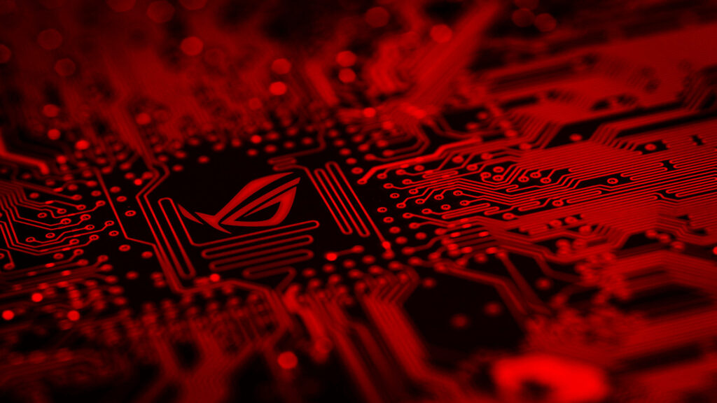 Tech Enthusiast's Delight: Captivating Close-up of a Gaming-Ready Circuit Board Adorned with Vibrant Red Accents and the Iconic Asus Logo Wallpaper
