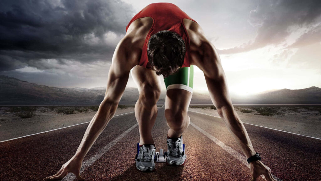 Powerful Sprinter Ready to Launch: Determination Wallpaper Background