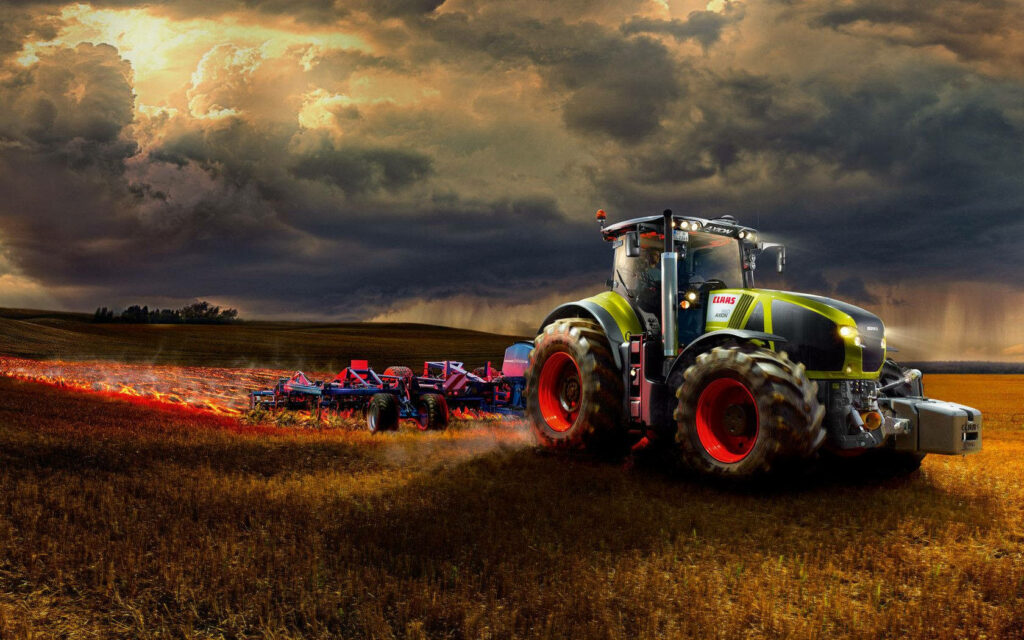 Powerful tractor plowing vast agricultural field under dramatic cloudy sky modern farming background Wallpaper