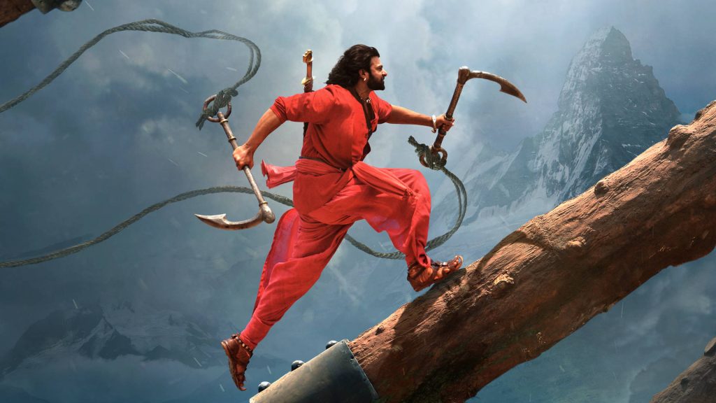 Prabhas as Baahubali leaping on log with hooked ropes snow mountains dramatic action wallpaper