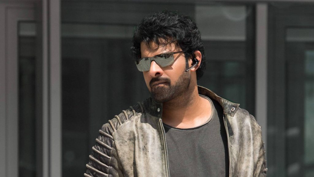 Prabhas rugged look in distressed leather jacket and mirrored sunglasses urban action wallpaper