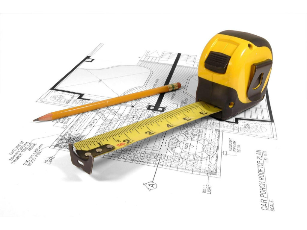 Yellow tape measure and pencil on architectural floor plan showing civil engineering precision Wallpaper