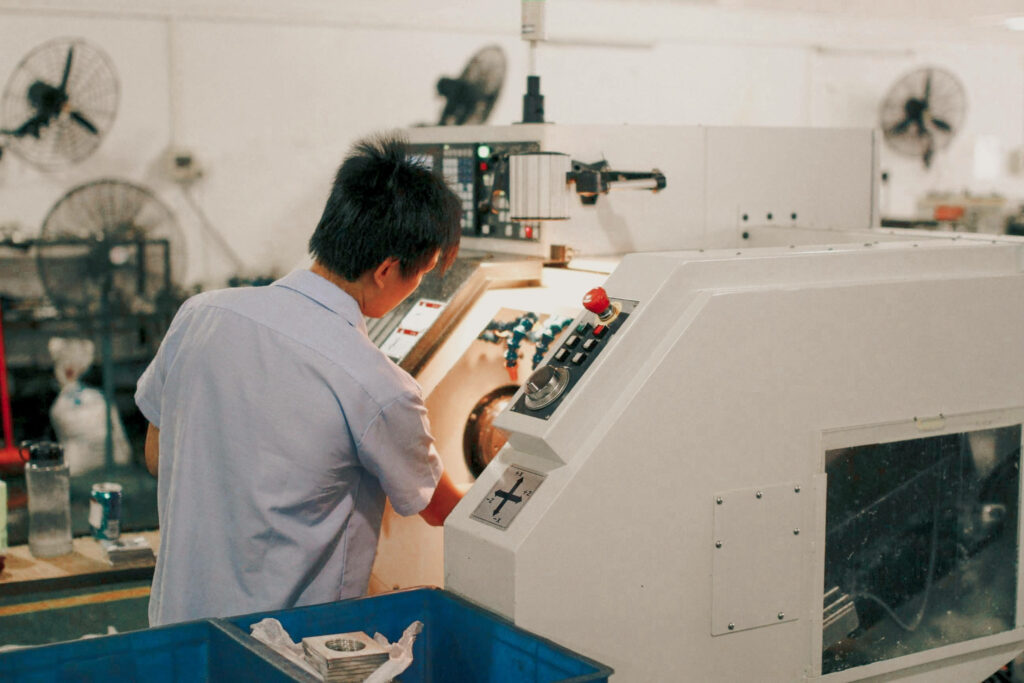 Focused Machinery Operator in Professional Workshop - Industrial Wallpaper