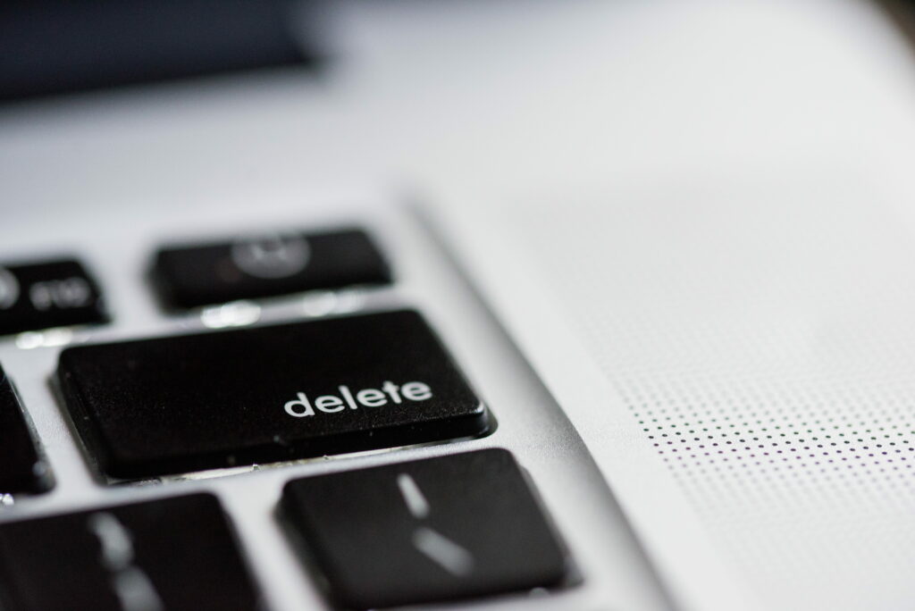 Modern black keyboard detail with delete key in focus for tech enthusiasts and digital workflow efficiency concept. Wallpaper
