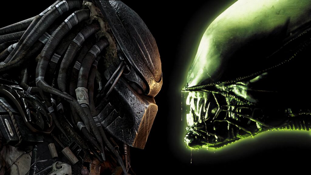 Close-up intense Predator versus Alien face-off wallpaper highlighting menacing features dark background