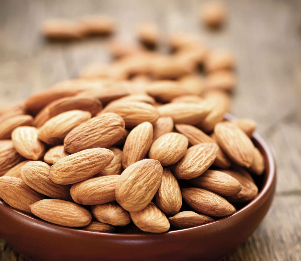 Premium Almond Nuts in Rustic Bowl - Nature's Texture Wallpaper