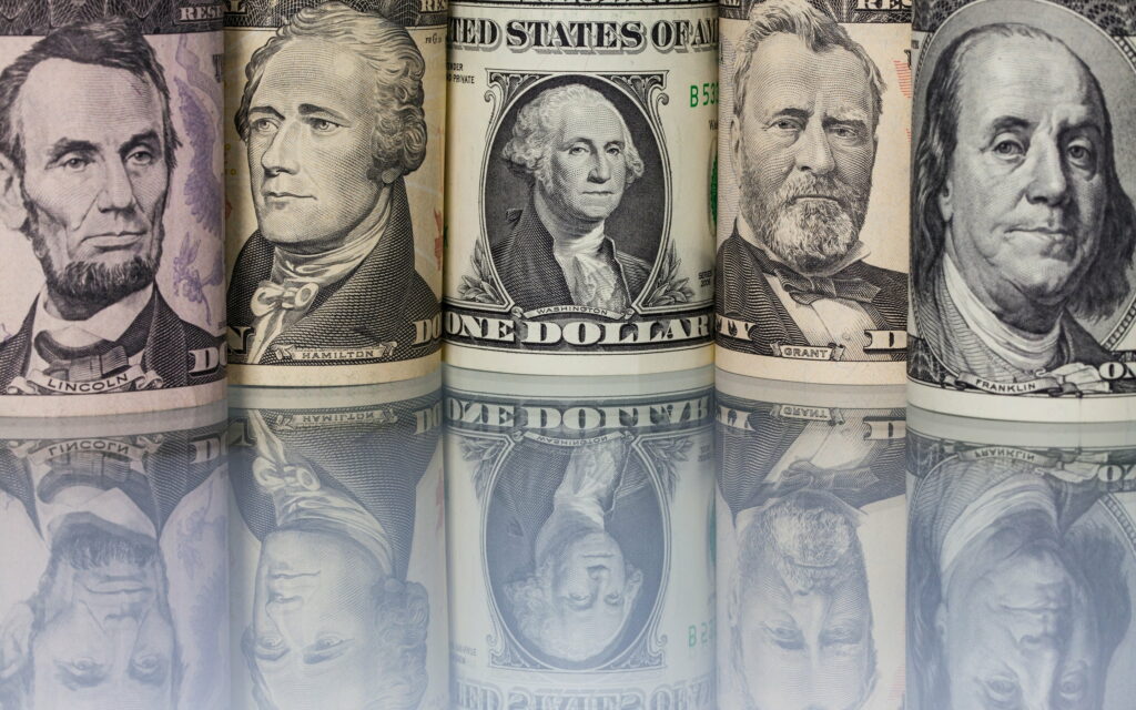 The Faces of Wealth: A Majestic US Dollar Showcase - QHD Wallpaper Background