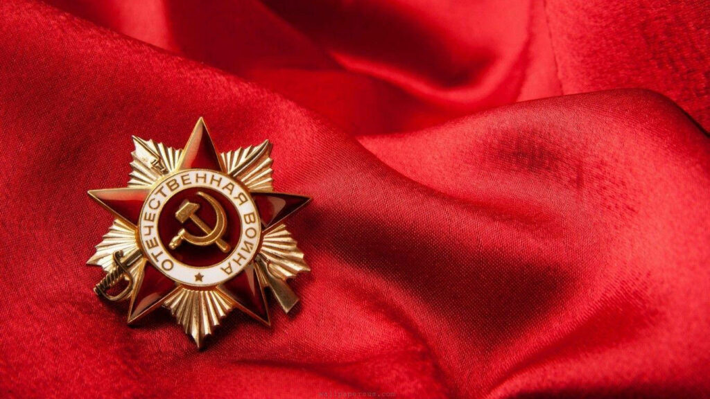 Symbolic Soviet Union: An Intense Shot of the Hammer and Sickle on Red Fabric Wallpaper