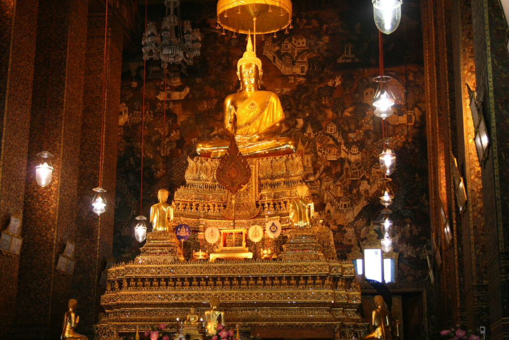 Principal Buddha statue at Wat Pho Bangkok with intricate golden temple decorations wallpaper