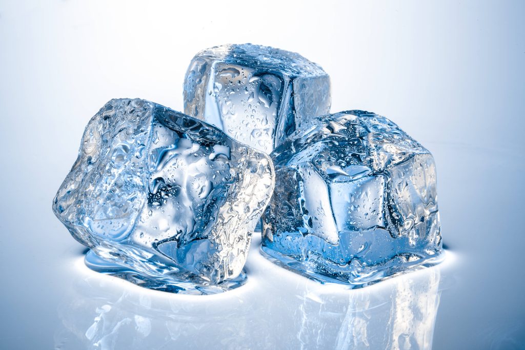 Close-up of three clear melting ice cubes on bright white background crisp cool blue tones wallpaper