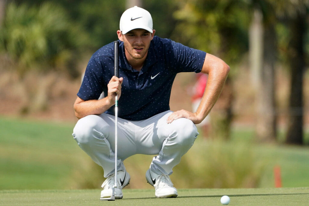 Pro Golfer Aaron Wise concentrating on golf course strategy dynamic sports wallpaper background