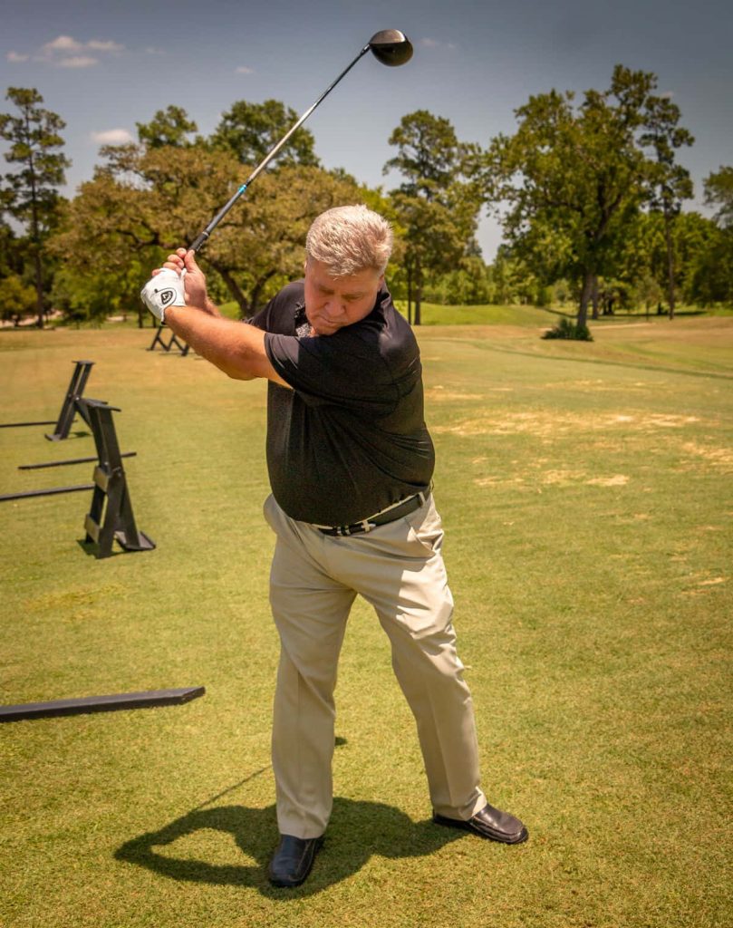 Pro golfer Hal Sutton mid-swing tee shot golf course sunny backdrop sports wallpaper