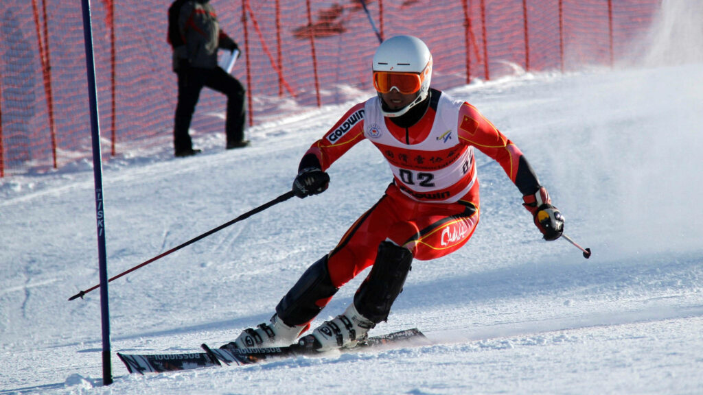 Expert Alpine Skier in Red Suit | Slalom Course Wallpaper Background